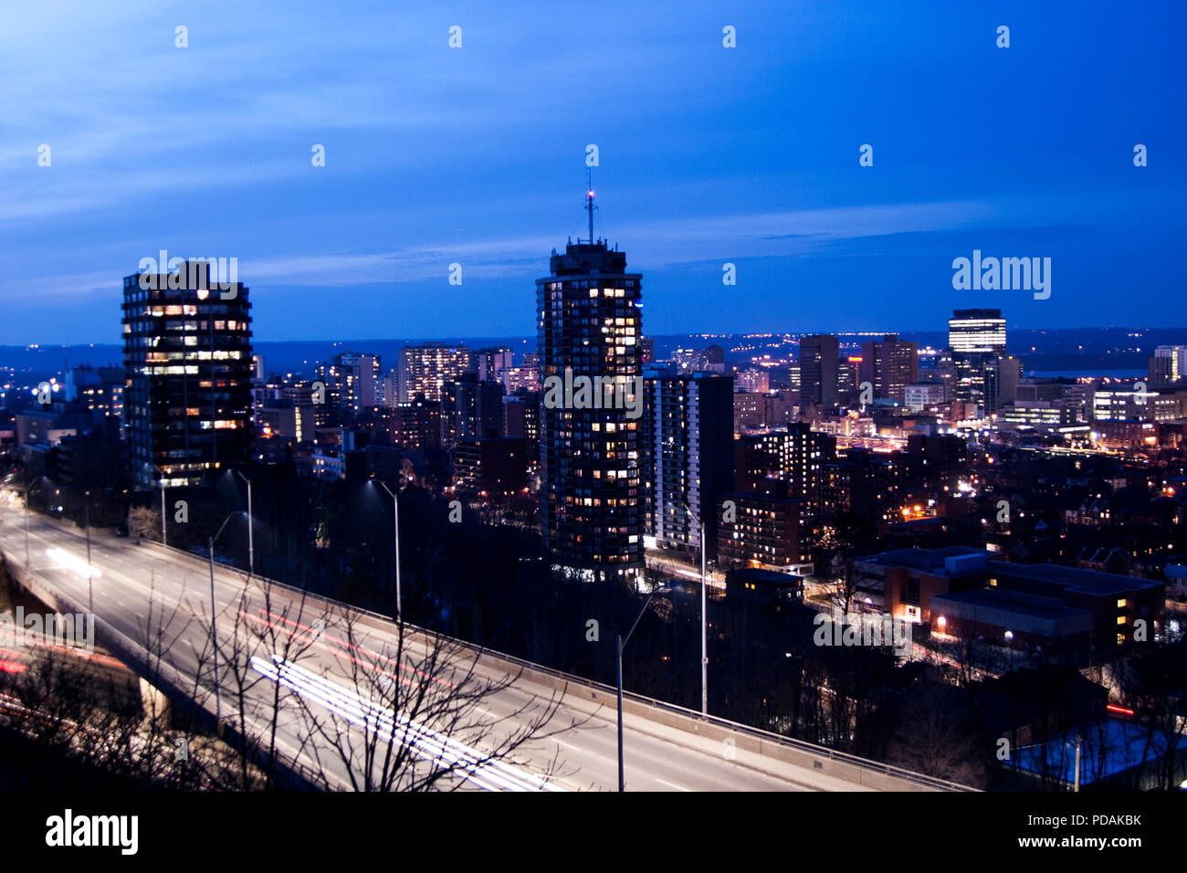 City buildings and homes at night. Night time city panorama. Stock Photo