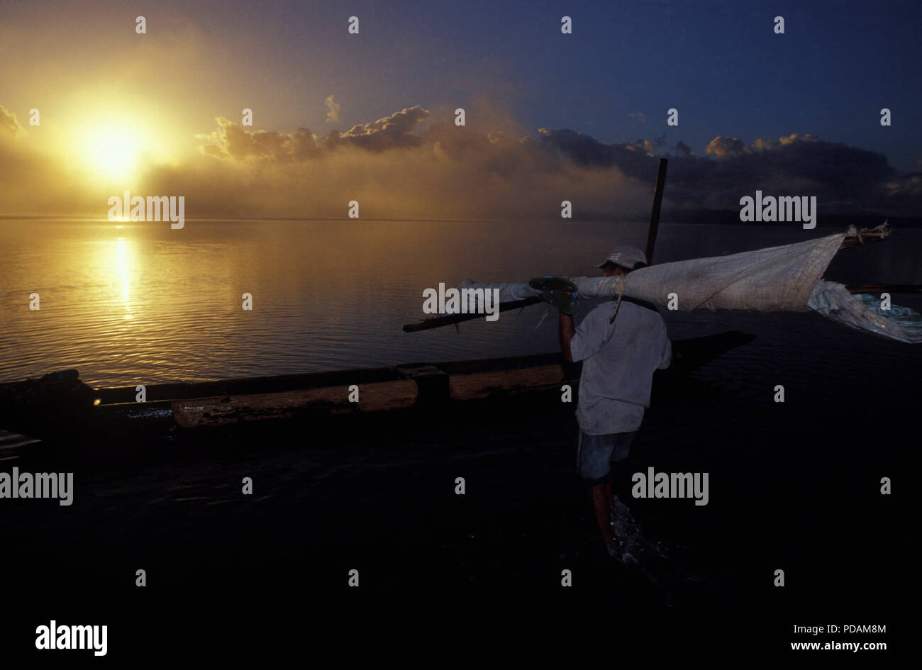 Fishing, fisherman going to work at sunrise, quiet sea landscape, early morning mist dissipating. Bahia State, Brazil. Stock Photo