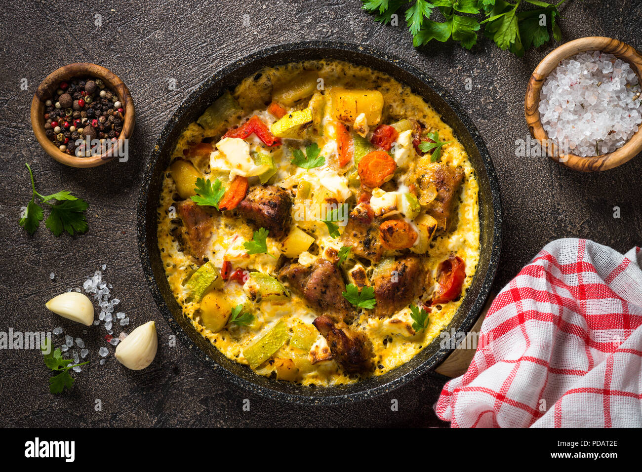 Frittata with meat and vegetables on dark background. Stock Photo