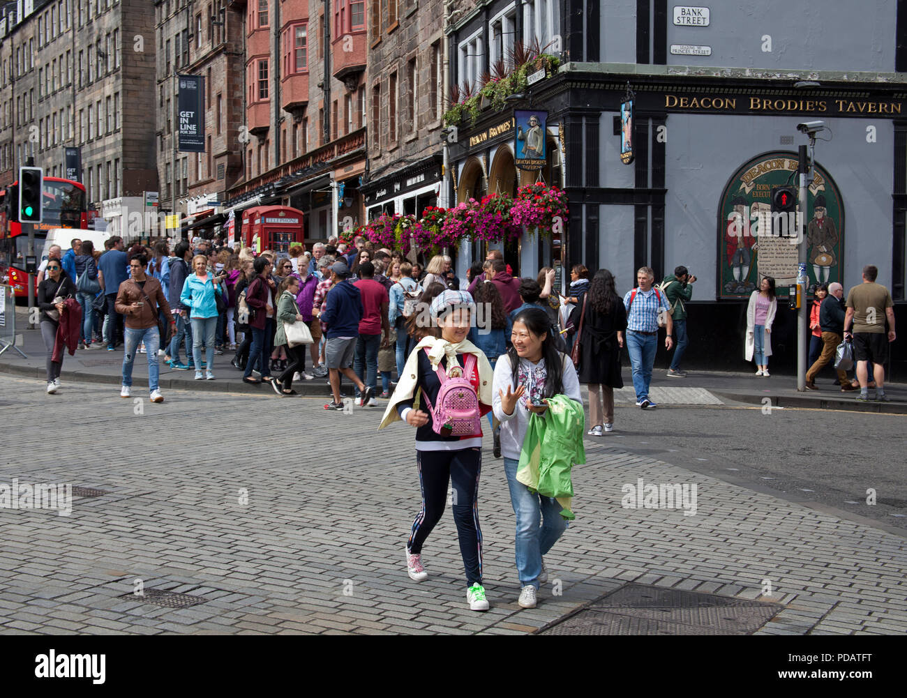 Tourists crossing road, Edinburgh city centre, Scotland, UK Stock Photo