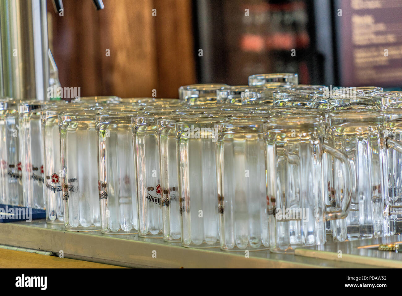 Clean beer glasses on a bar in the early afternoon before the start of