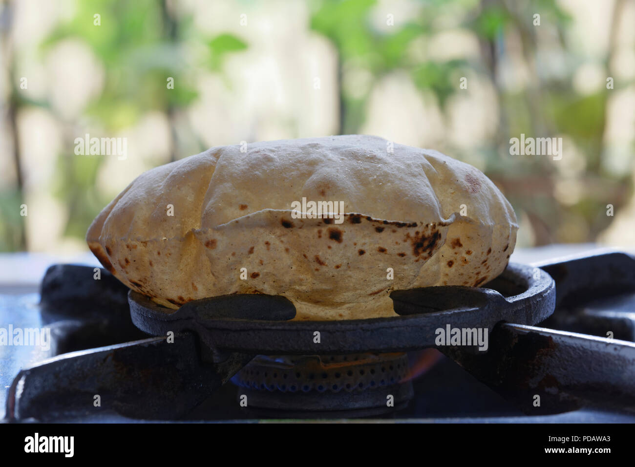 phulka-a-kind-of-chapati-home-made-indian-thin-bread-being-cooked-on