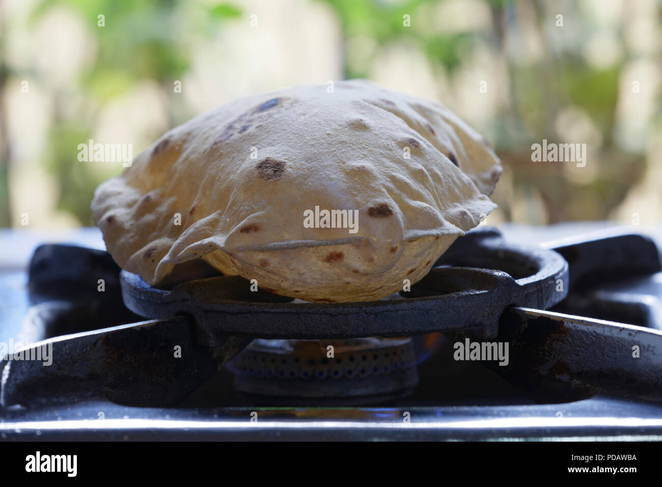 phulka-a-kind-of-chapati-home-made-indian-thin-bread-being-cooked-on