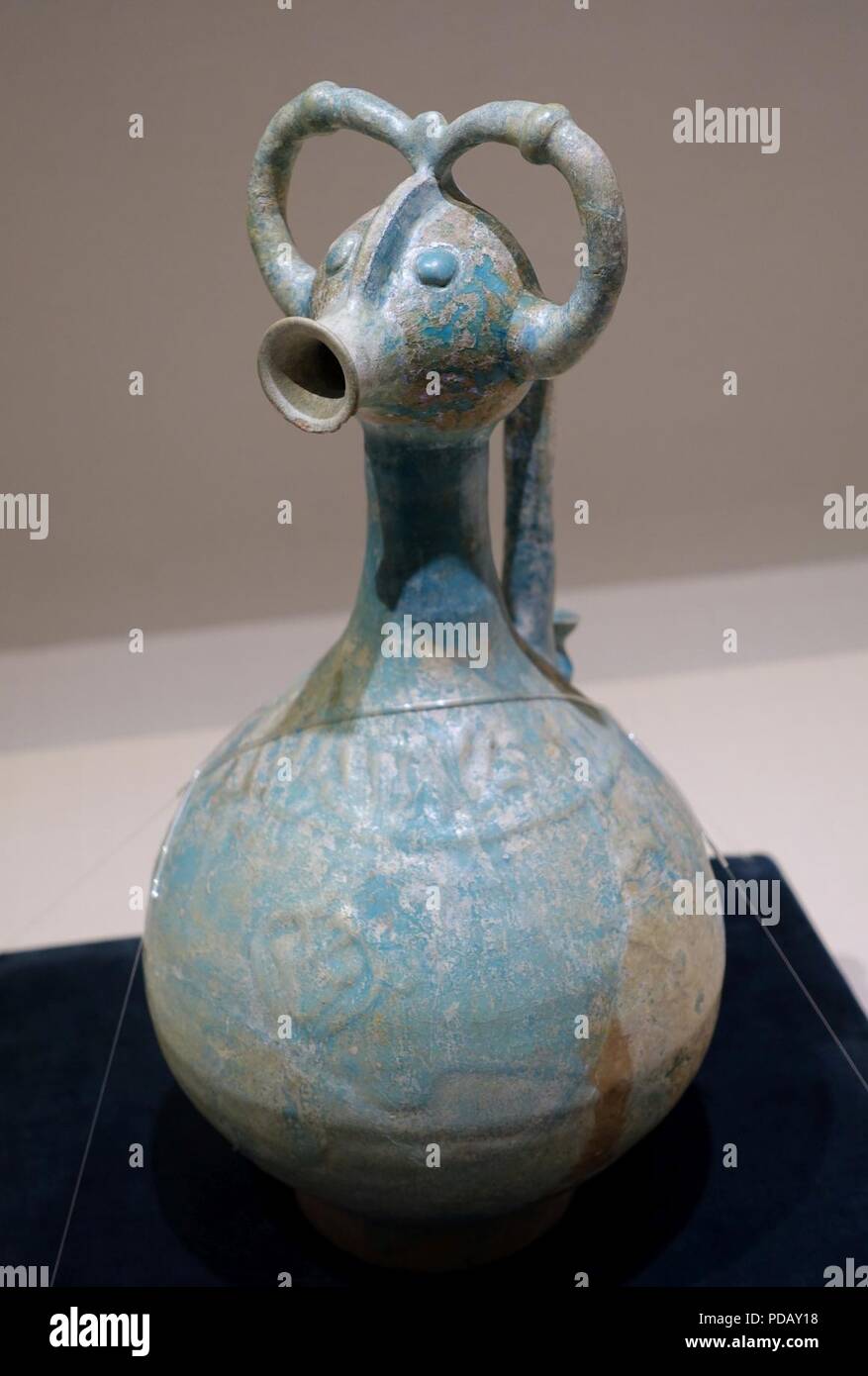 Animal-headed pitcher, Iran, 12th century AD, blue glaze with iridescence - Stock Photo