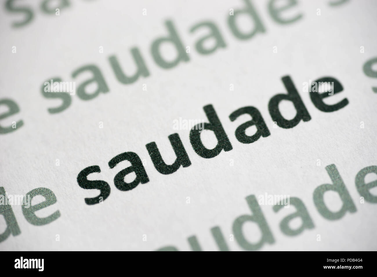 word saudade printed on white paper macro Stock Photo