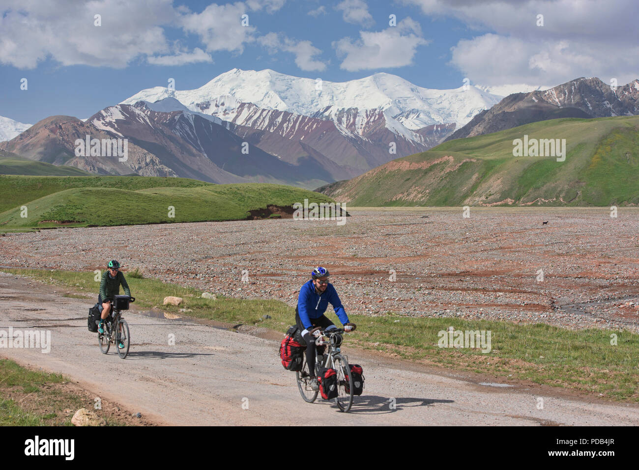 Bicyclists completing a ride of the Pamir Highway, Kyrgyzstan Stock Photo