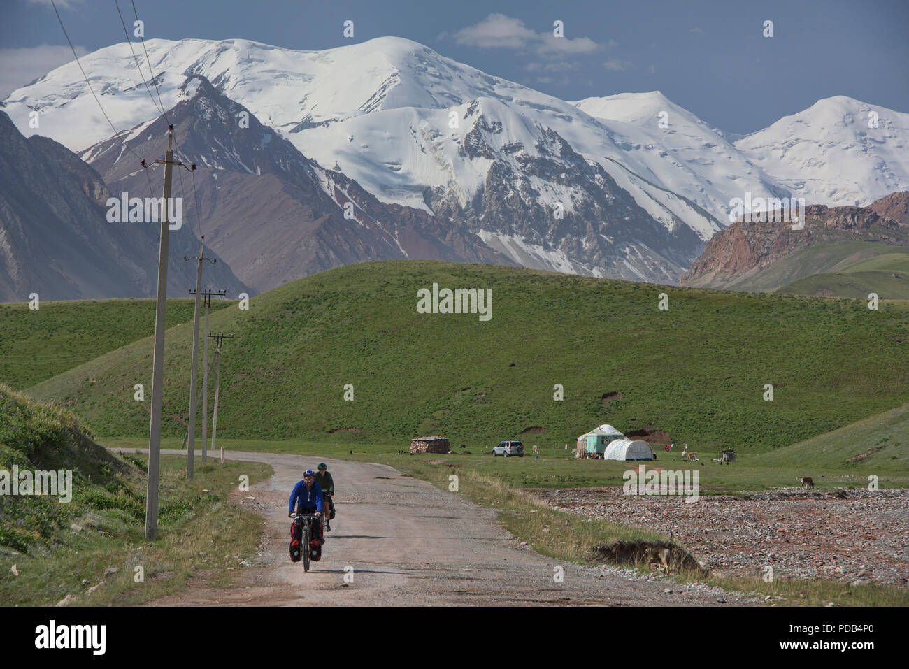 Bicyclists completing a ride of the Pamir Highway, Kyrgyzstan Stock Photo