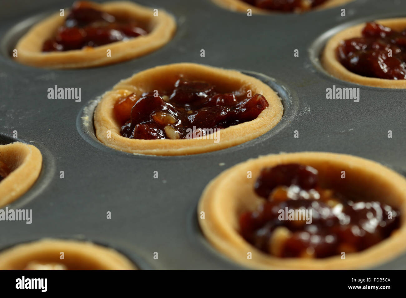 Mince Pies With Filling In A Metal Baking Tray Ready For Topping Stock Mince Pies With Filling In A Metal Baking Tray Ready For Topping Stock
