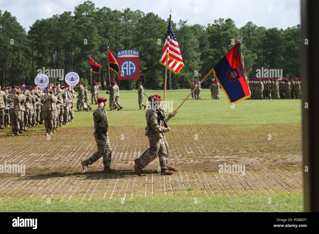 The 82nd Airborne Division color guard salutes during pass in review of a change of command ceremony at Pike Field on Fort Bragg, North Carolina, Aug. 2, 2018. The ceremony honored the U.S. Army Maj. Gen. Michael Kurilla, the outgoing division commanding general, and welcomed Maj. Gen. James Mingus, the incoming commanding general. (U.S. Army photo by Sgt. Michelle U. Blesam) Stock Photo