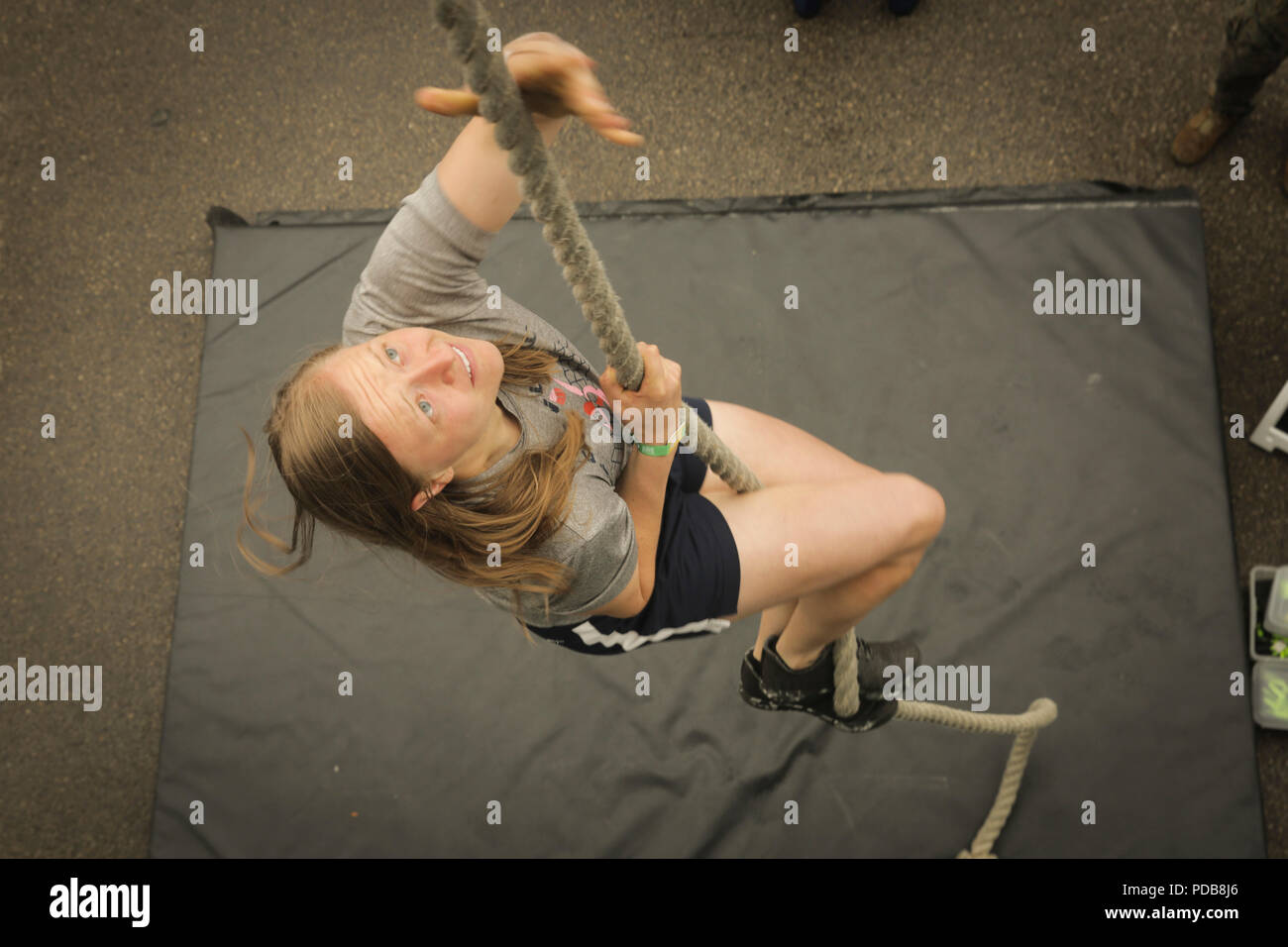 MADISON, Wisconsin – Jena Peters, a native of Sioux City, Iowa, climbs the  rope at the Marine Corps Battles Won Challenge trailer during the 2018  Reebok CrossFit Games at the Alliant Energy