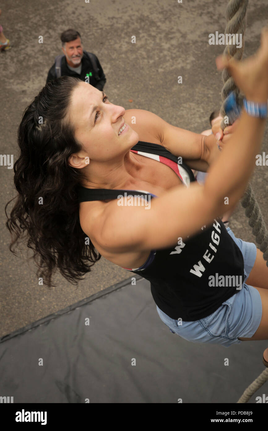 MADISON, Wisconsin – Amanda Link, a native of Cortland, New York, climbs  the rope at the Marine Corps Battles Won Challenge trailer during the 2018 Reebok  CrossFit Games at the Alliant Energy