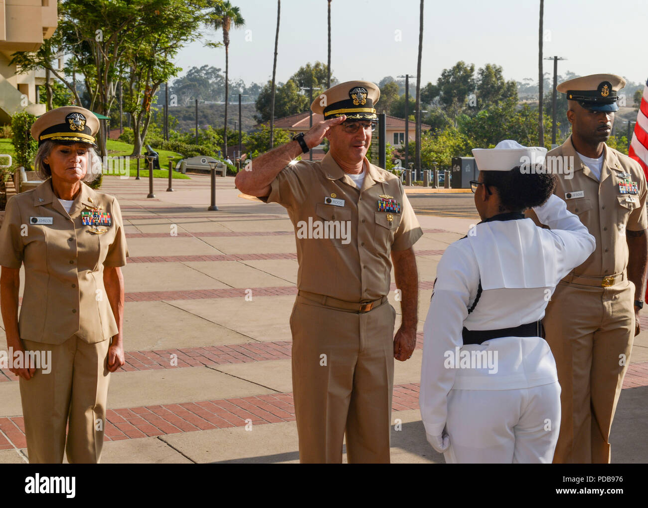 180803-N-PN275-1018 SAN DIEGO (August 03, 2018) Capt. Joel Roos, commanding officer of Naval Medical Center San Diego (NMCSD), returns a salute to Hospital Corpsman 3rd Class Kirsten Austin, during an awards ceremony. NMCSD recognized eight Sailors during the ceremony for their achievements. (U.S. Navy Photo by Mass Communication Specialist 2nd Class Zach Kreitzer) Stock Photo