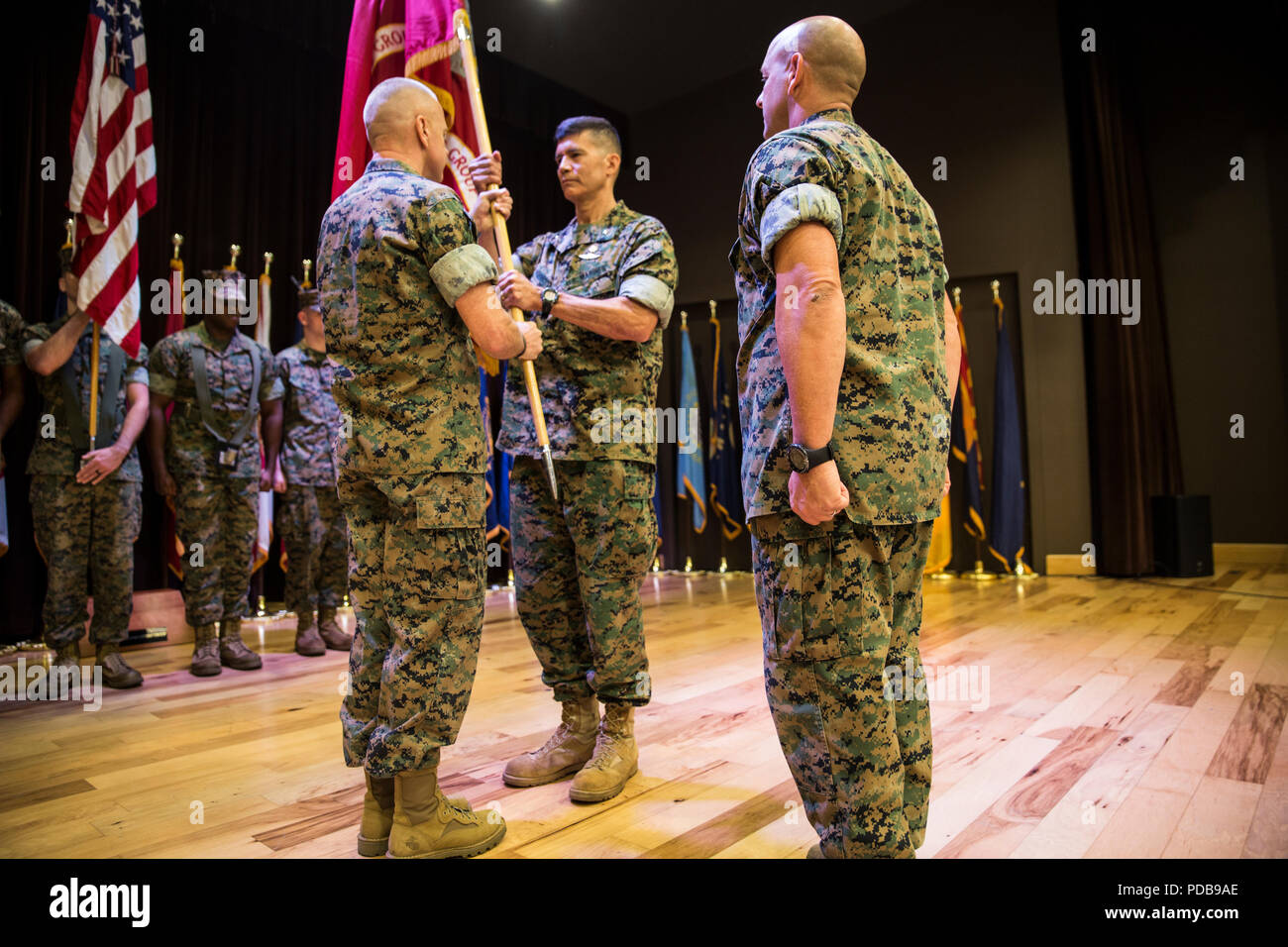 Brig. Gen. Mark Hashimoto, center, incoming commander of Force Headquarters Group, receives the colors from Maj. Gen. Michael F. Fahey, left, outgoing commander of FHG, during the change of command ceremony at the Federal City Auditorium, New Orleans, Aug. 3, 2018. While addressing the attendees, Fahey expressed his total confidence in Hashimoto as the new commander. (U.S. Marine Corps photo by Sgt. Melissa Martens) Stock Photo