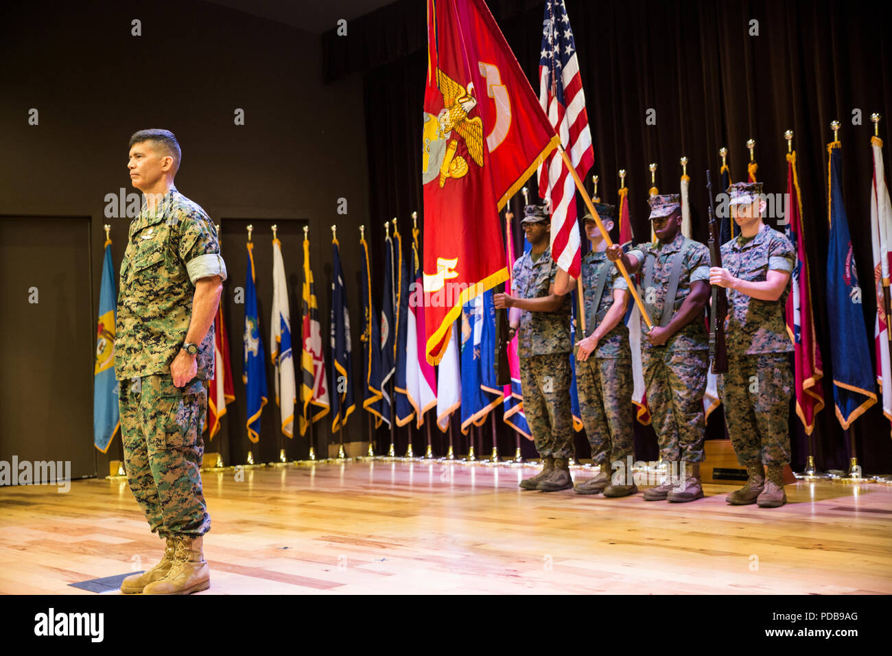 Brig. Gen. Mark Hashimoto, commander of Force Headquarters Group, stands at attention as the colors are presented in honor of Hashimoto taking command of FHG at the Federal City Auditorium, New Orleans, Aug. 3, 2018. Hashimoto relieved Maj. Gen. Michael F. Fahey, who served as the commander of FHG from 2016-2018. (U.S. Marine Corps photo by Sgt. Melissa Martens) Stock Photo