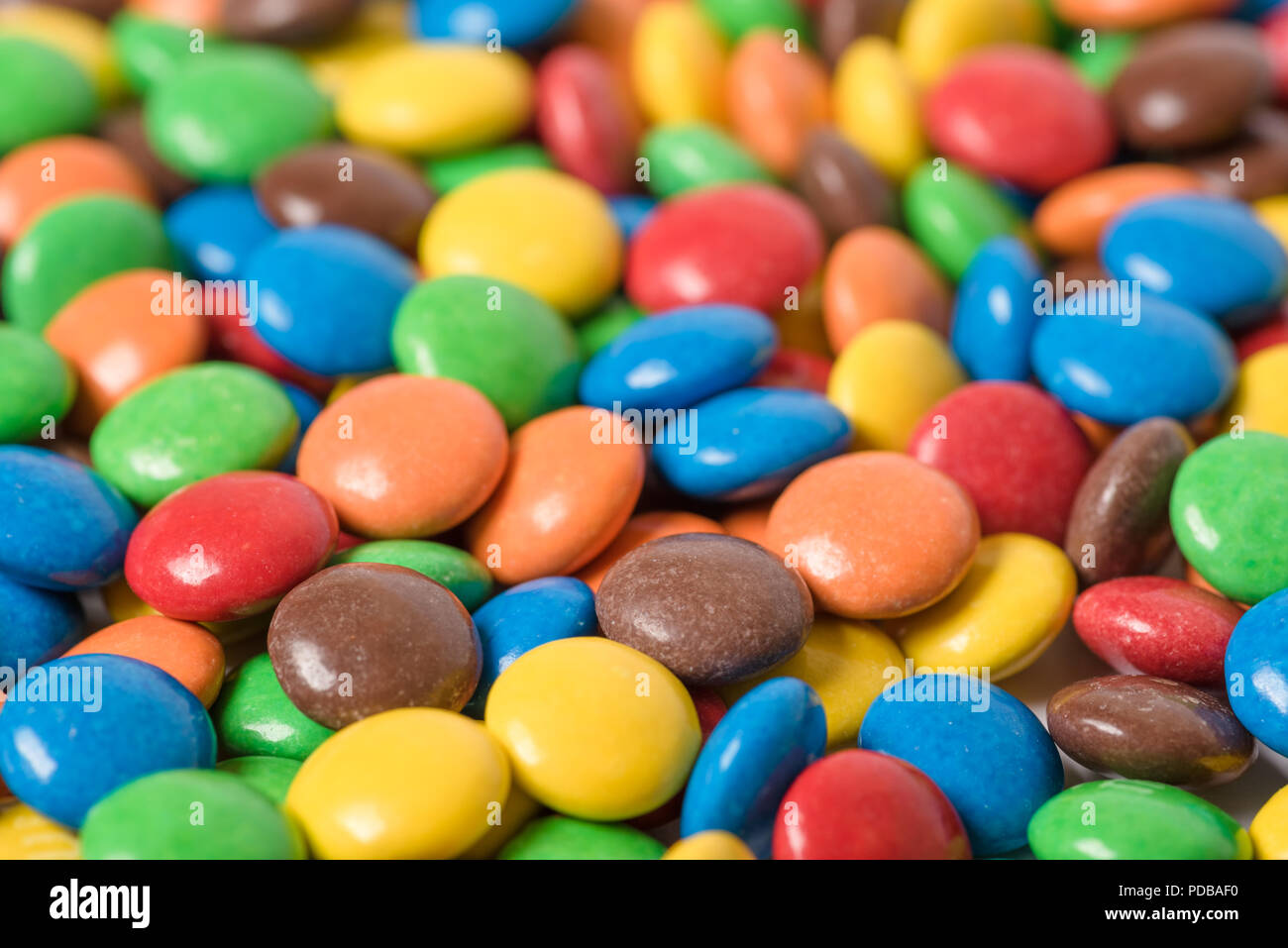 Multi colored m&m candies randomly arranged Stock Photo