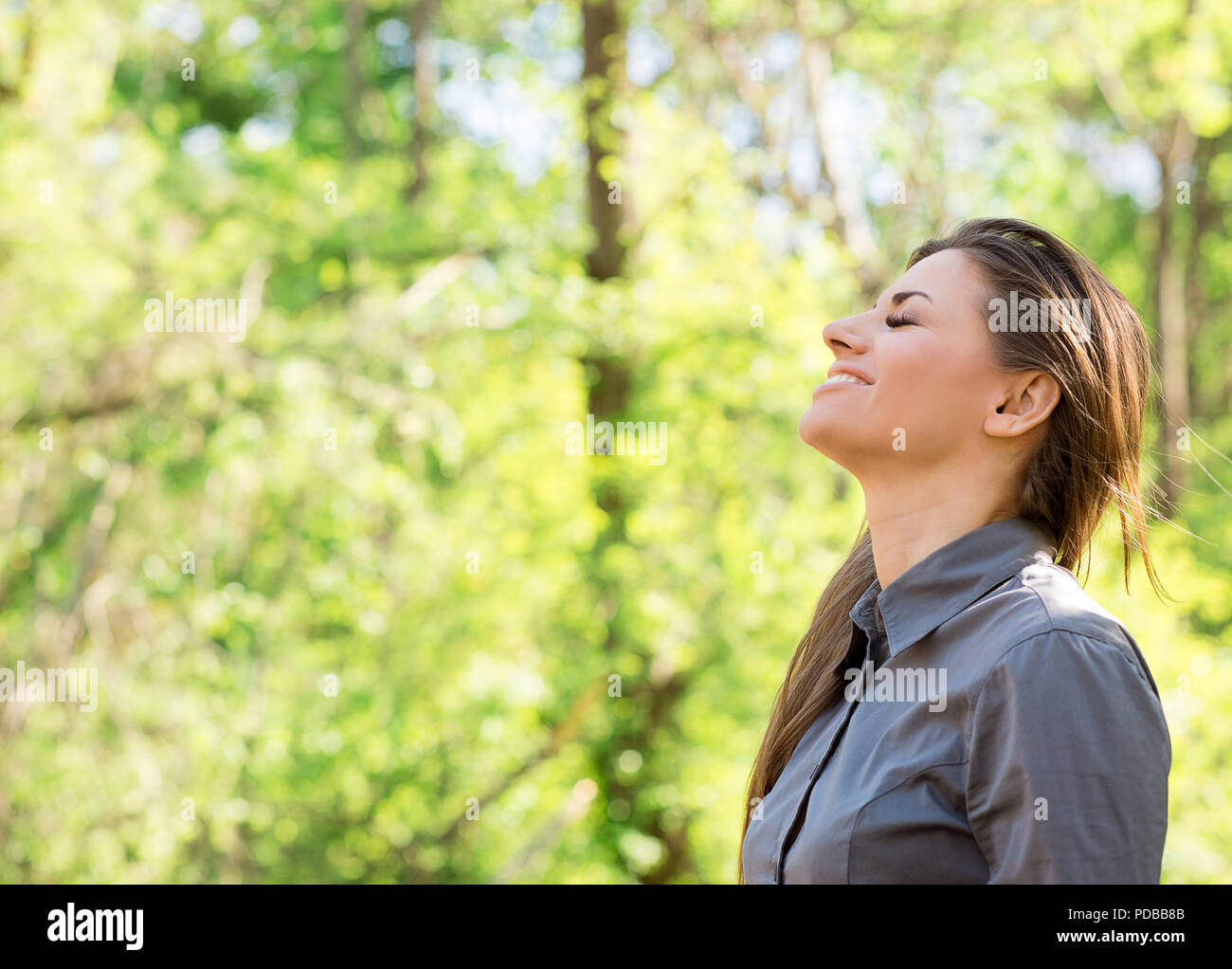 Side view of happy woman taking deep breath and closing eyes enjoying freedom and nature summer vacation Stock Photo