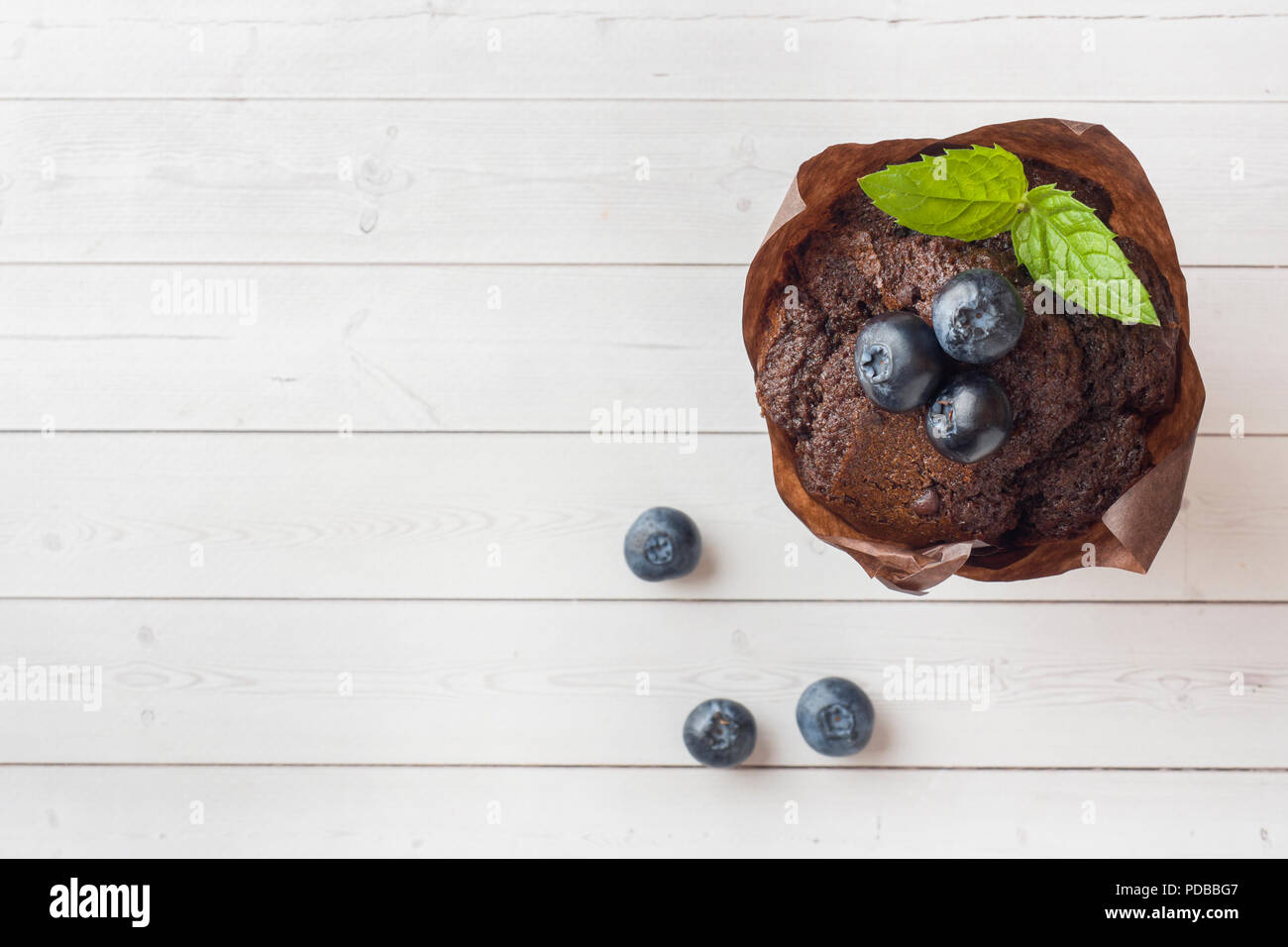 Chocolate cake with mint and blueberries on a light table Stock Photo ...