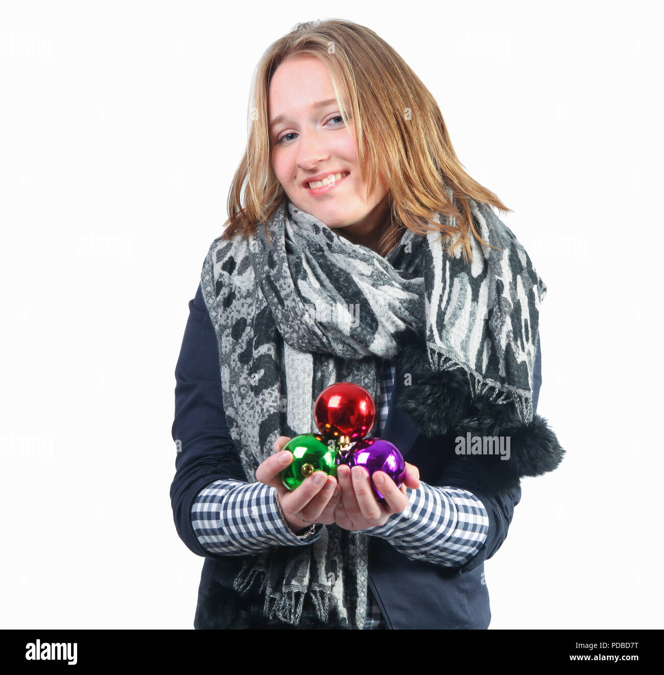 Woman with scarf holding Christmas baubles Stock Photo