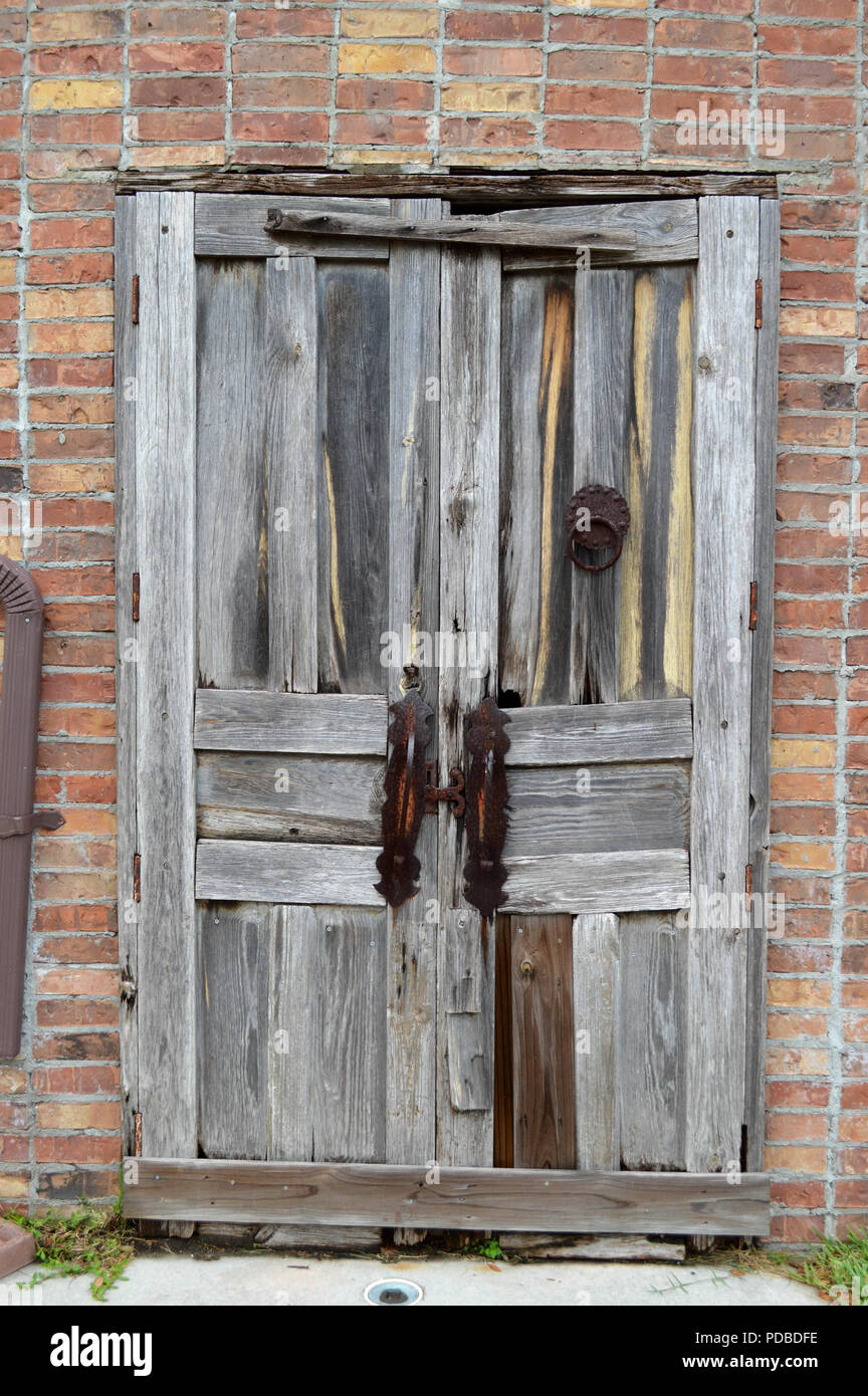 Weathered Antique Wooden Door With Rusted Knocker and Rusted Handles As