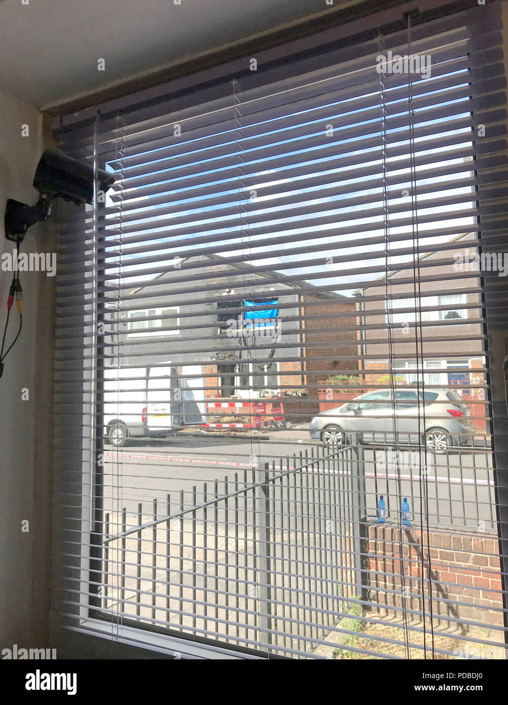 Cctv camera in the window of flat on adolphus street hires stock