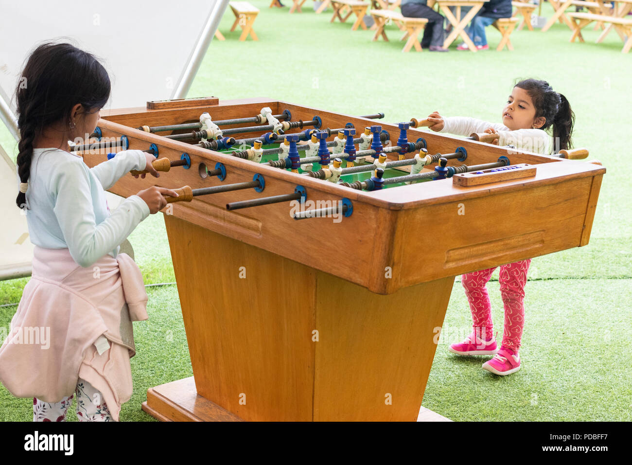 Cute little girl playing table football in the park Stock Photo