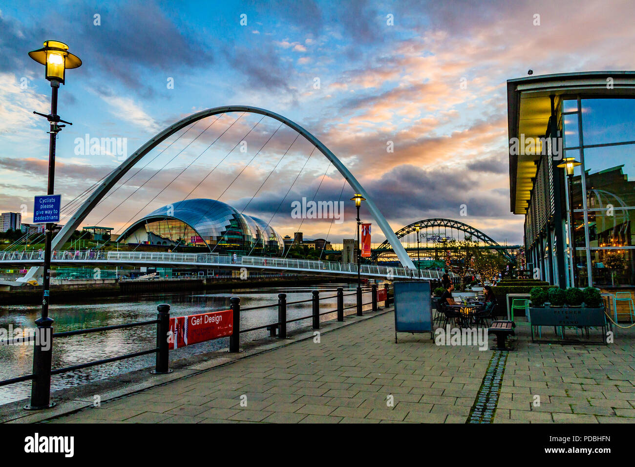 View of the Tyne River from outside Pitcher & Piano bar, looking towards the Millennium Bridge, Tyne Bridge and the Sage at sunset. Newcastle, UK. Stock Photo