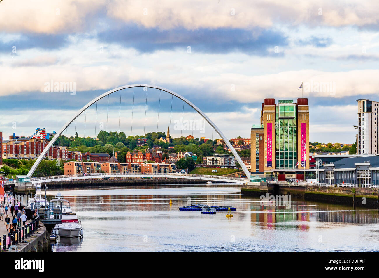 The Baltic Centre for Contemporary Art in converted flour mill, and the Millennium Bridge,  Gateshead, UK Stock Photo