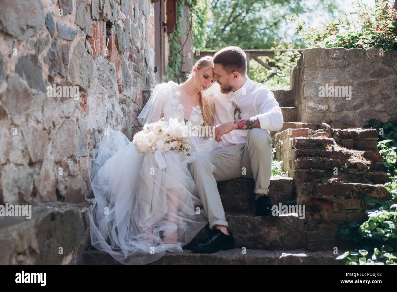 Bride sitting on stairs hi-res stock photography and images - Alamy