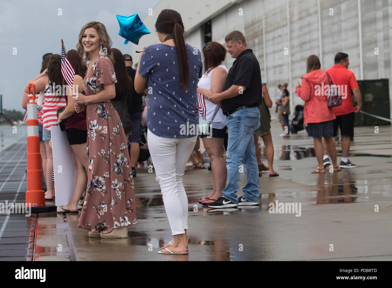 Friends and families await the return of Marines with the 26th Marine Expeditionary Unit (MEU) at Marine Corps Air Station New River, Aug. 5, 2018. Marines with the 26th MEU returned home from a six-month deployment at sea to the U.S. Central, Africa and European Command areas of operation. (U.S. Marine Corps photo by Cpl. Tiana Boyd) Stock Photo