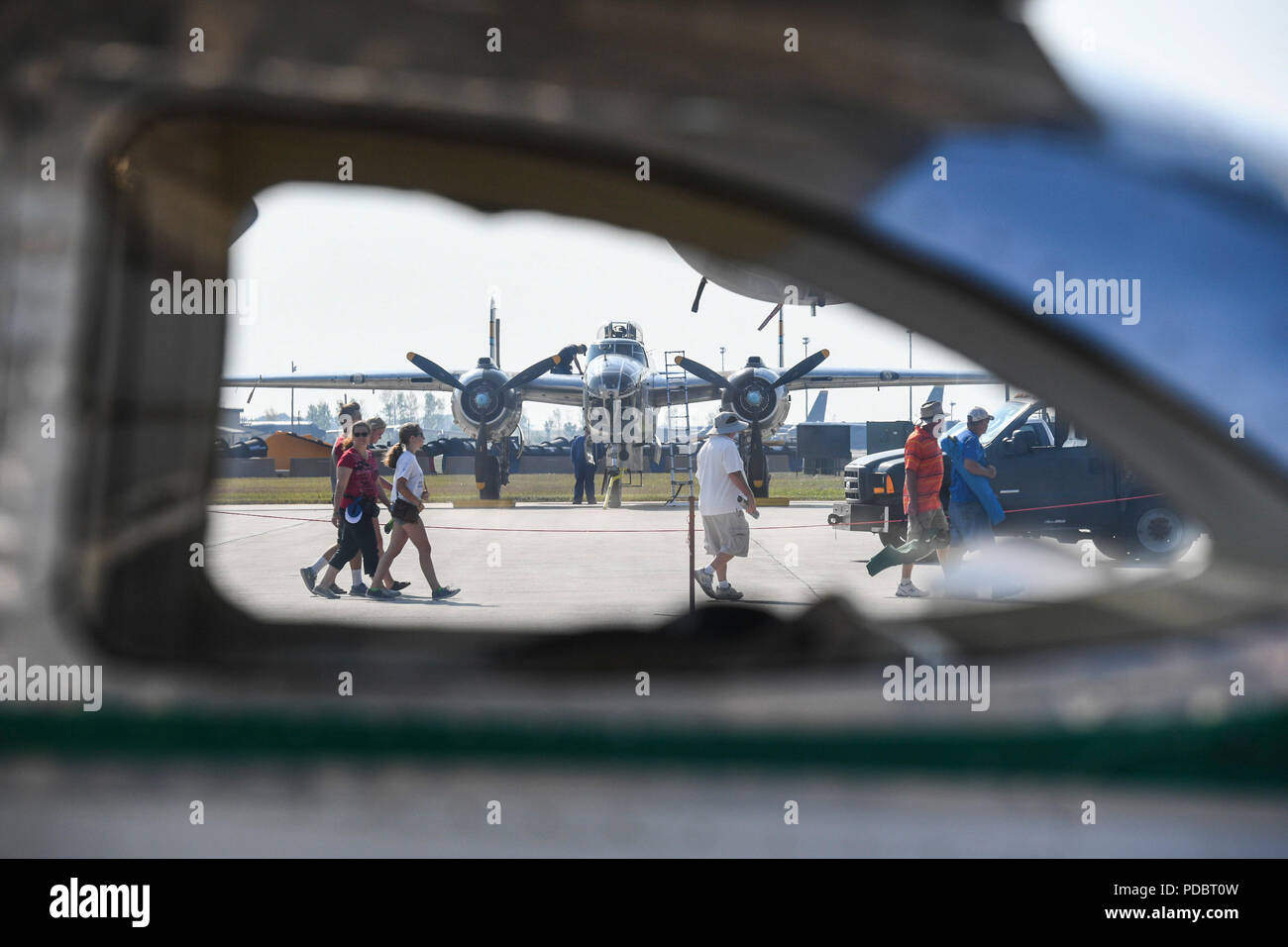 An aircrew member cleans a B25 Mitchell during the Northern Neighbors