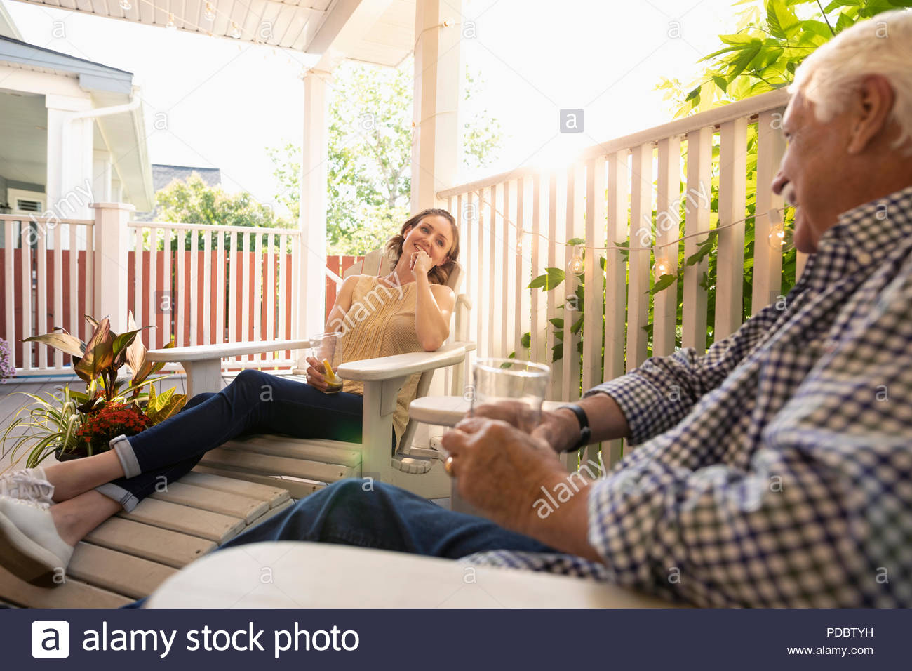 Family relaxing on porch together hi-res stock photography and images ...