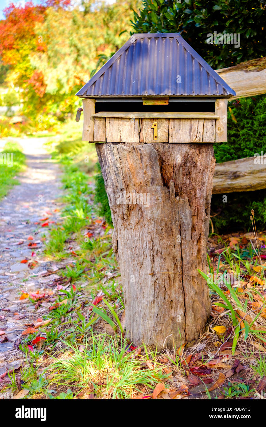 Australian home handmade wooden letterbox with number one installed on frontyard Stock Photo