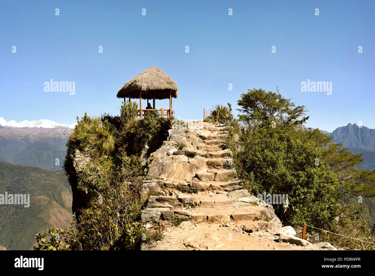 Hut and Inca trail stone path at the summit of Machu Picchu Mountain (Montaña Machupicchu) at 3,082 meters above sea level. Peru. Jul 2018 Stock Photo