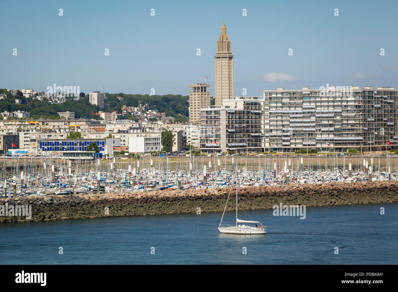 A view from the sea showing The Church of St. Joseph behind the Residence de France apartments and the marina at Le Havre, Normandy, France Stock Photo
