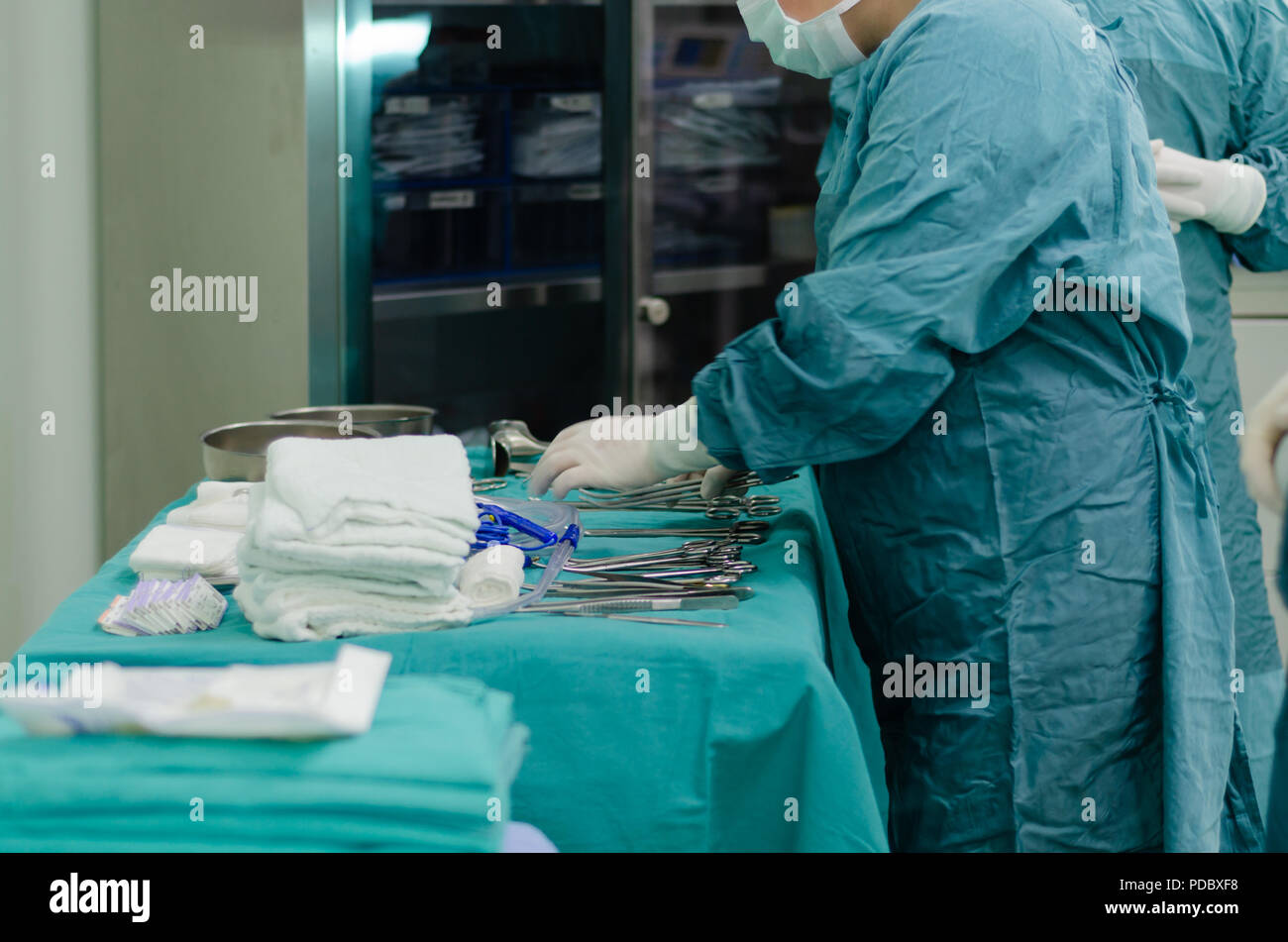 Scrub nurse is preparing medical instruments for operation Stock Photo