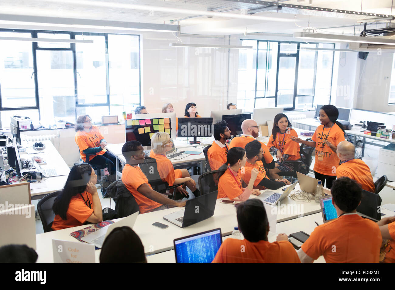 Hackers coding for charity at hackathon Stock Photo - Alamy