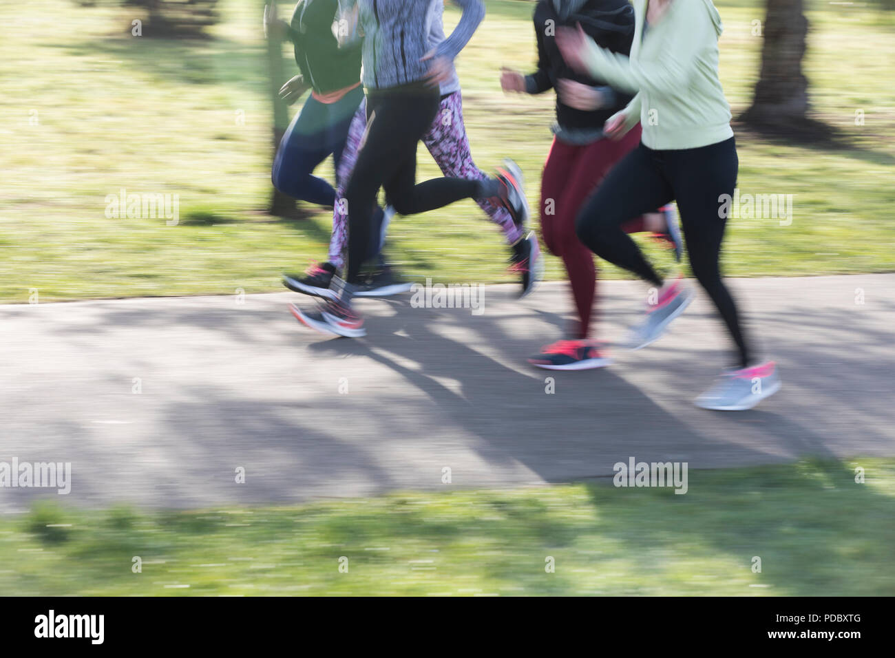 Runners on the move, running in park Stock Photo