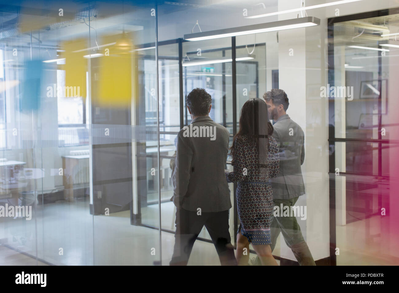 Business people walking and talking in office corridor Stock Photo
