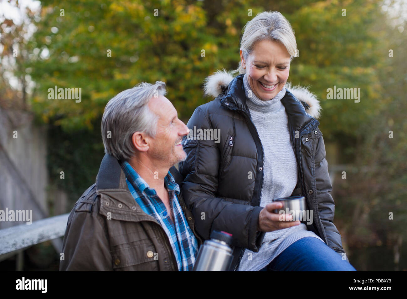 Mature couple drinking coffee in park Stock Photo