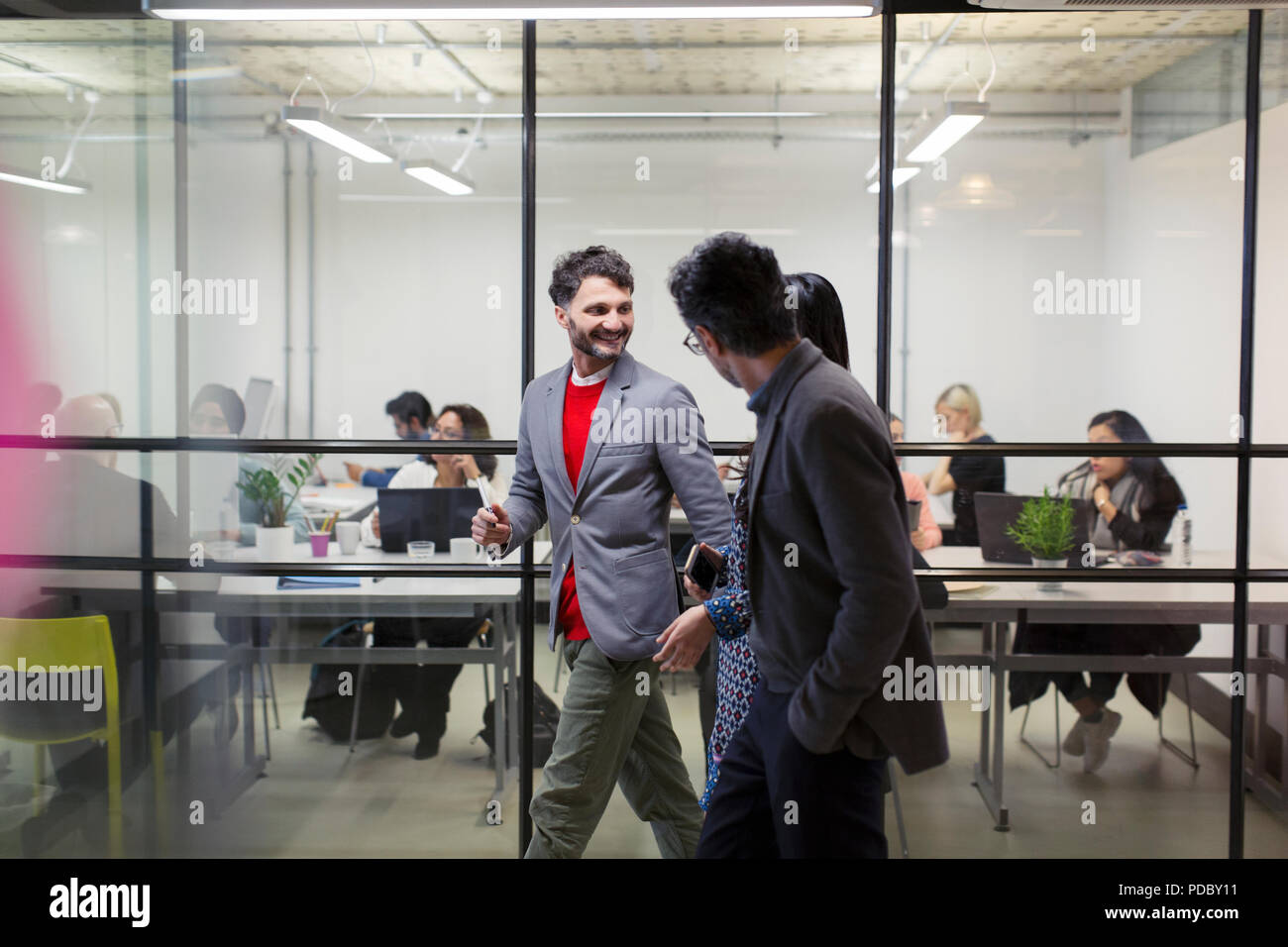 Business people walking and talking in office Stock Photo