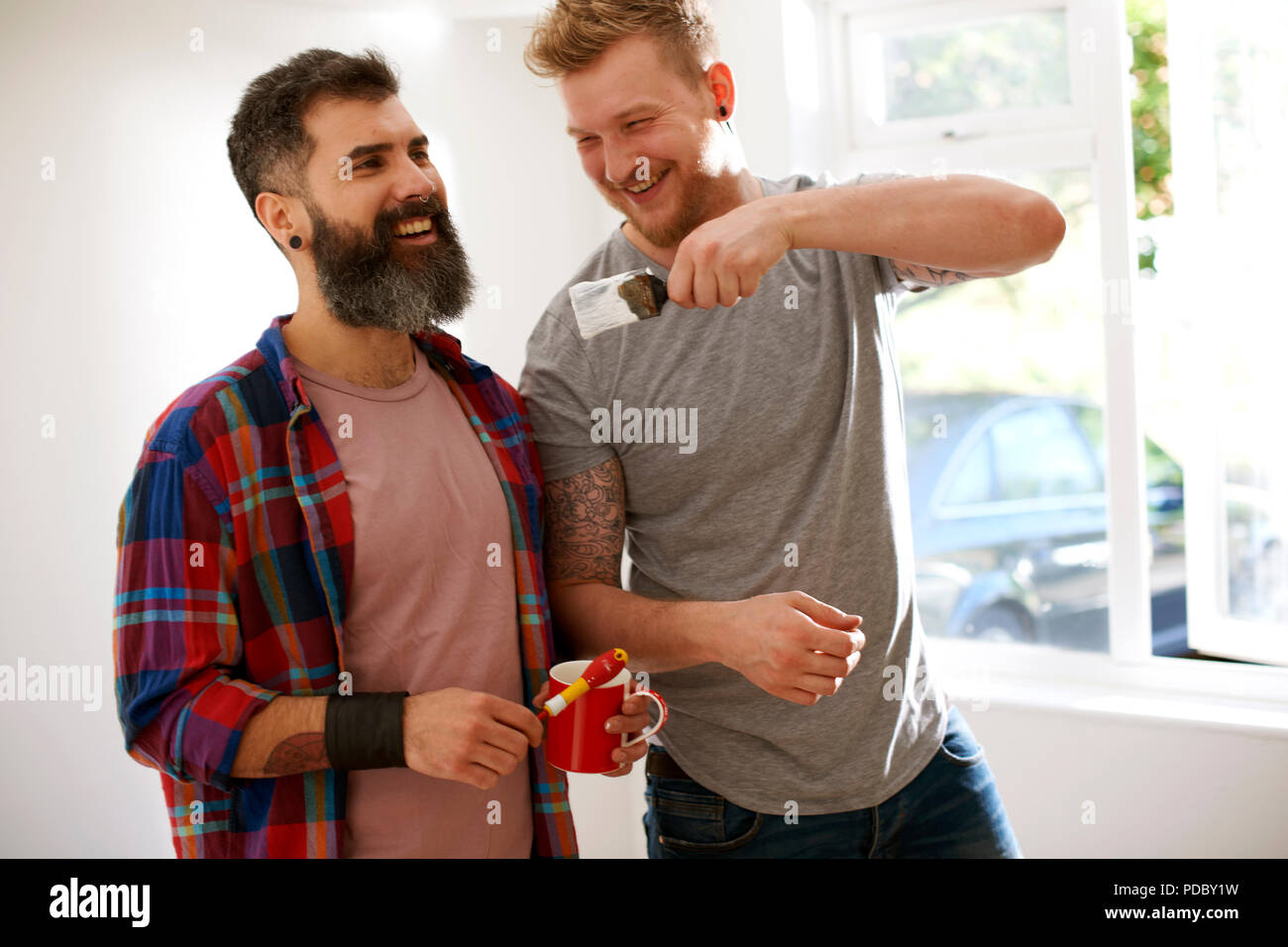 Happy male gay couple painting Stock Photo