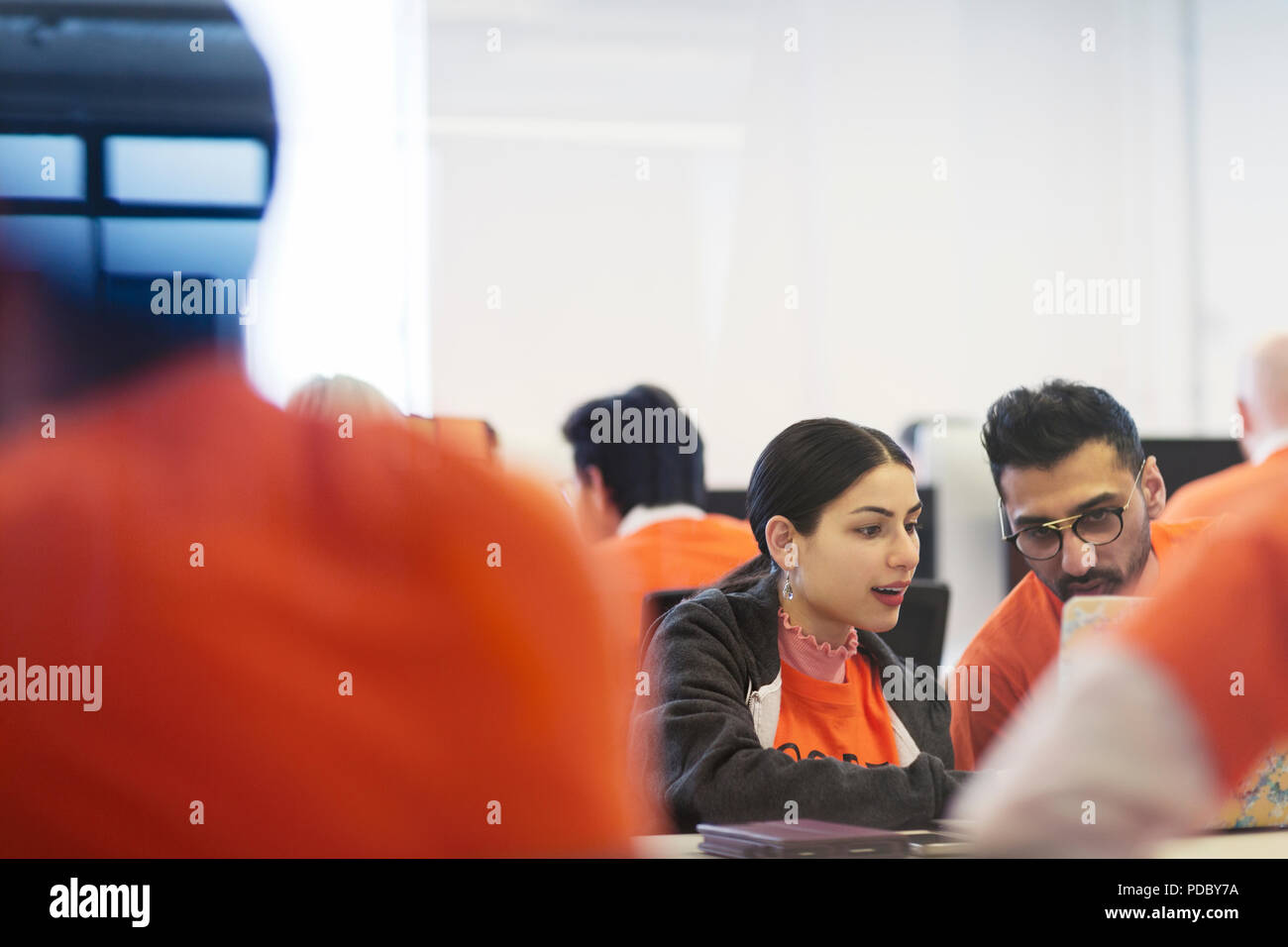 Focused hackers coding for charity at hackathon Stock Photo