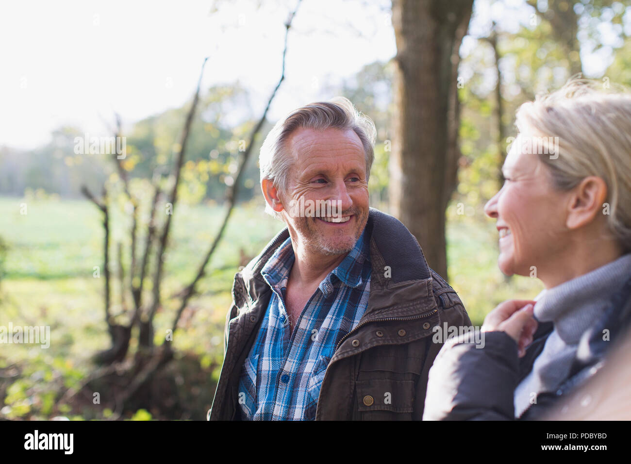 Happy mature couple in sunny autumn park Stock Photo