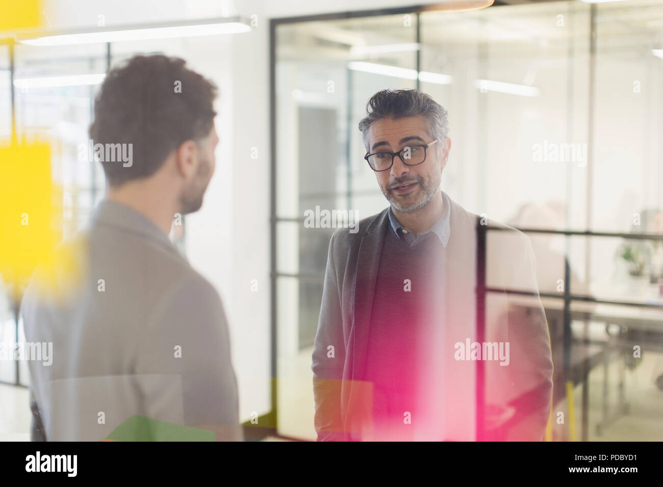 Businessmen talking in office Stock Photo