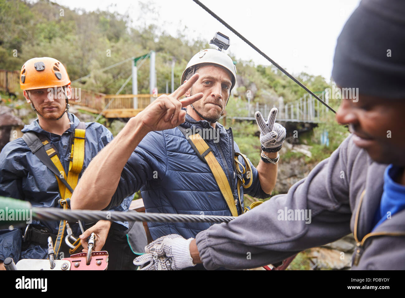 Portrait confident man with wearable camera preparing to zip line Stock Photo