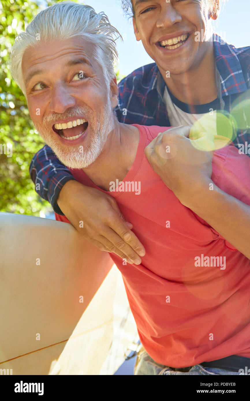 Playful father and son piggybacking Stock Photo