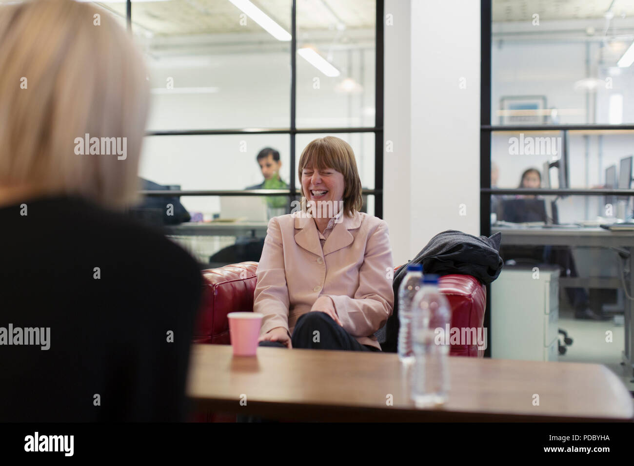 Laughing businesswoman in meeting Stock Photo