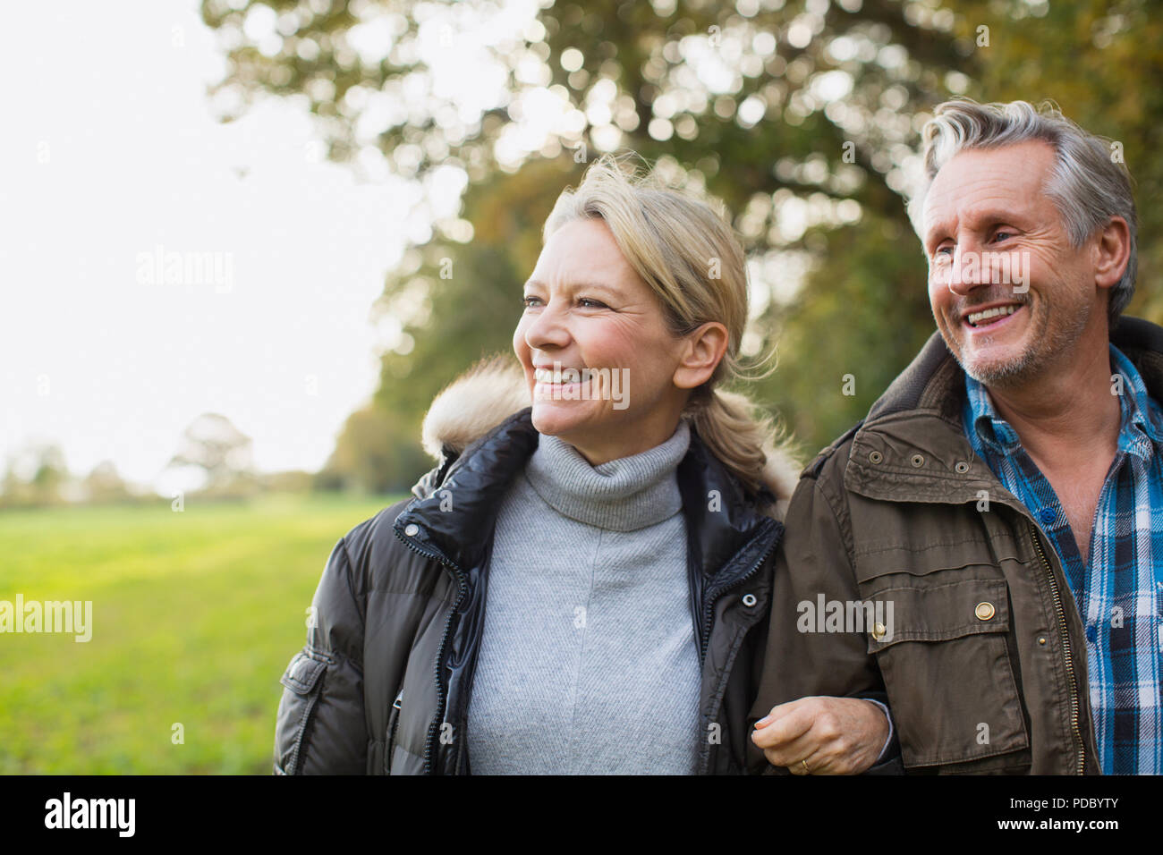 Happy, carefree mature couple in autumn park Stock Photo