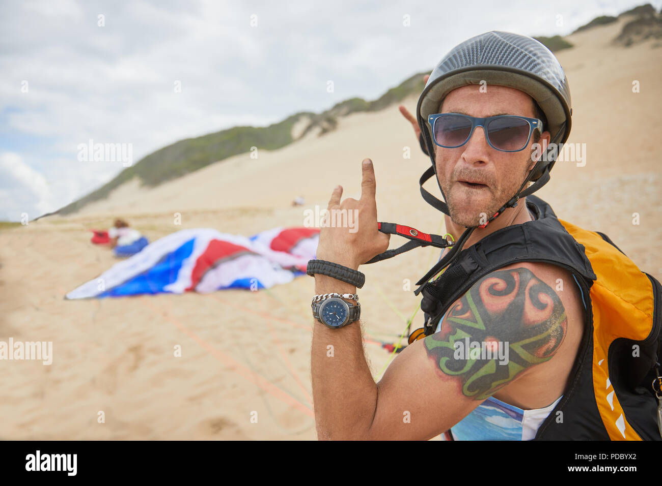 Portrait confident, carefree male paraglider on beach Stock Photo
