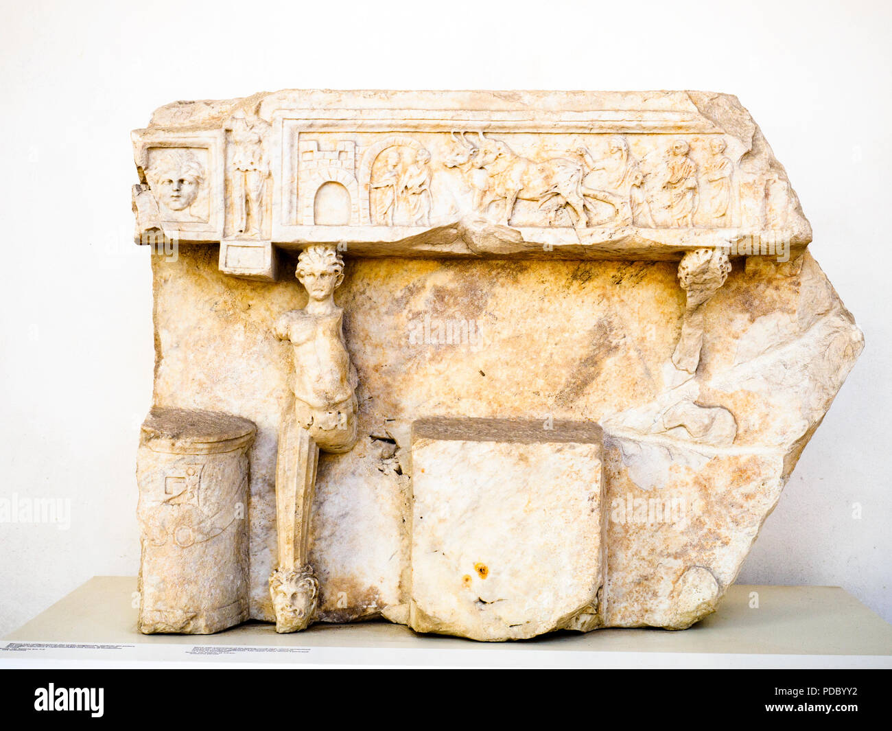 Block with a portrayal of the folding curule seat, which symbolised the power of senior magistrates endowed with imperium, known as curules magistrates. The upper frieze shows a portrayal of a city's foundation from via Salaria (antonine period) - National Roman Museum - The Baths of Diocletian - Rome, Italy Stock Photo